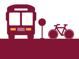 Ilustração na cor vermelho vinho de ícones representando, ao lado esquerdo um ônibus, no centro uma placa sinalizando uma placa de ônibus e do lado direito uma bicicleta.